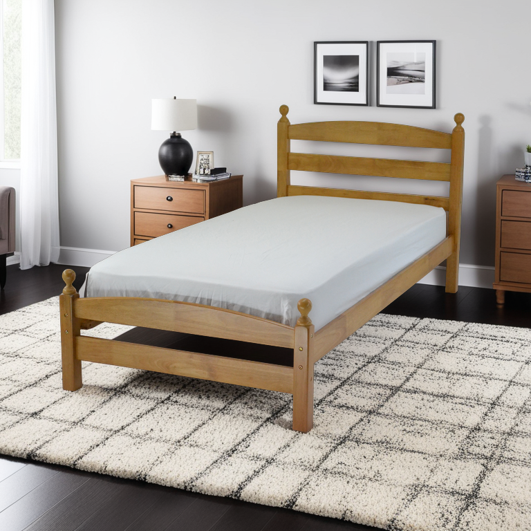 A single wooden bed frame with a beige headboard and footboard, placed on a bedroom setting with a mattress on top, a nightstand on each side, and a decorative rug on the floor.