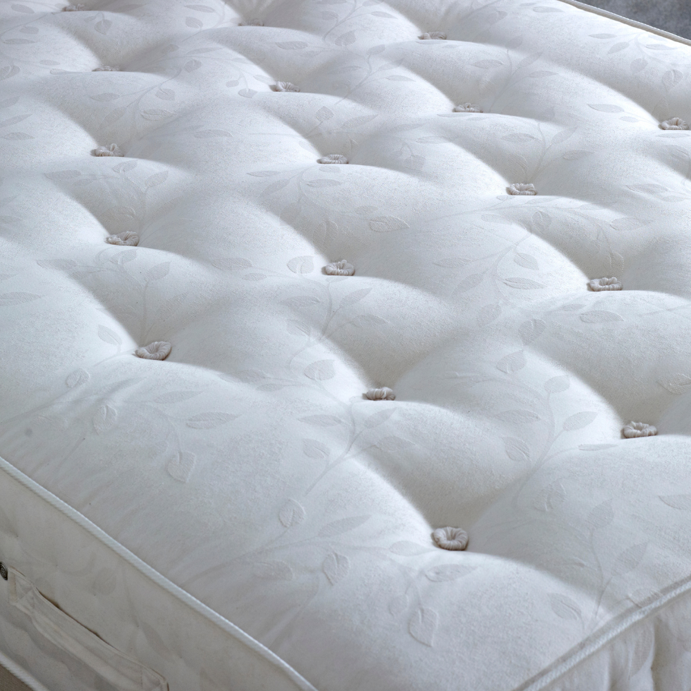Close-up of a white tufted mattress