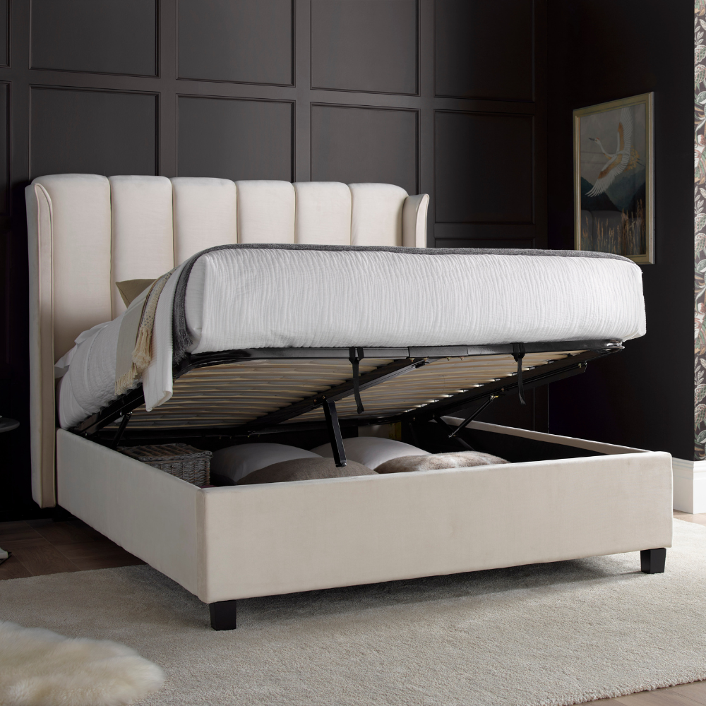 Beige upholstered bed with storage drawers in a bedroom setting