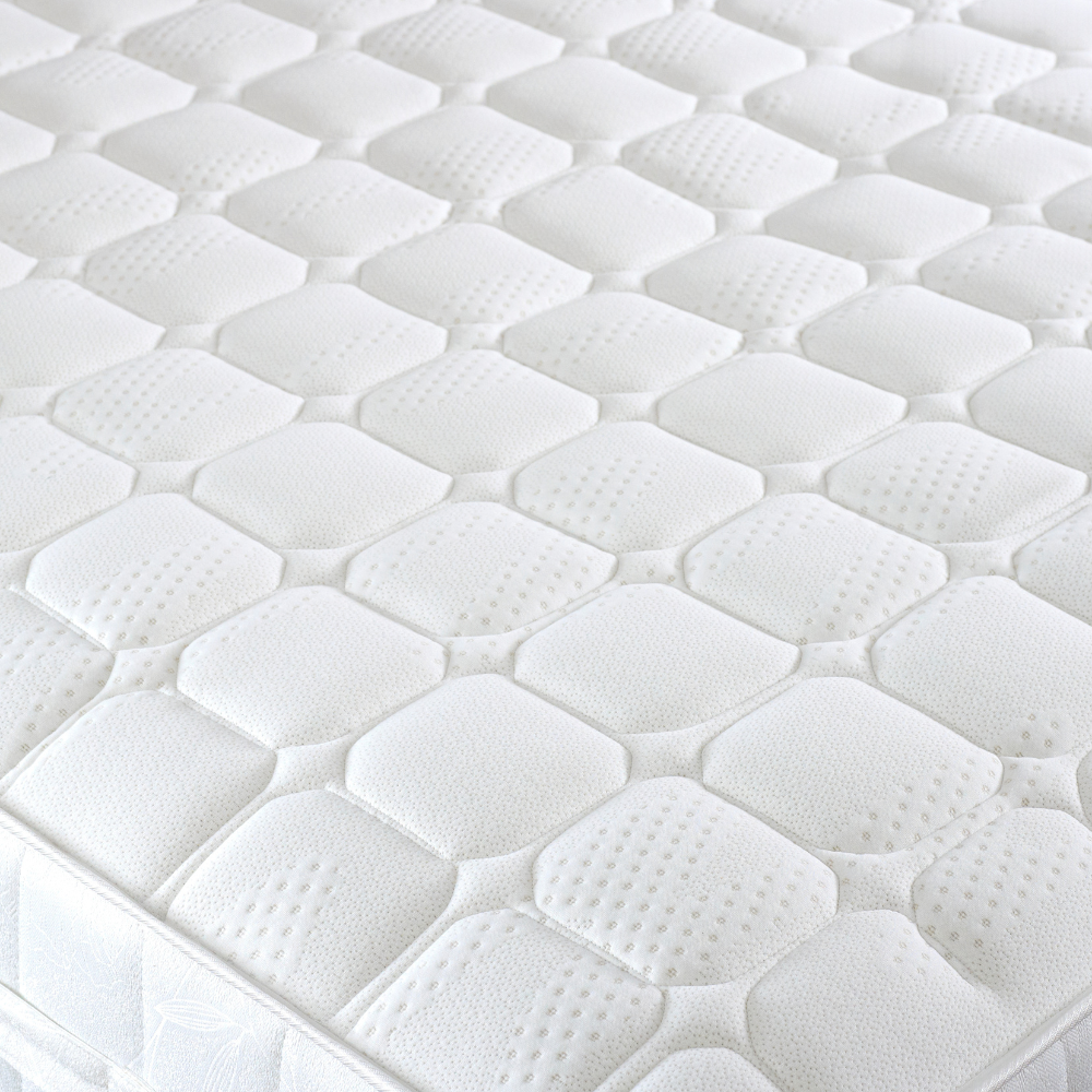 Close-up of a white mattress with hexagonal foam cells