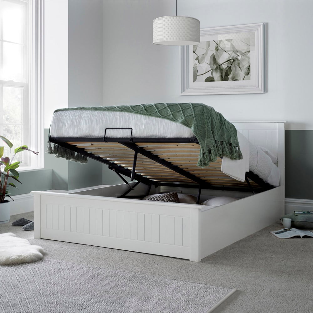 White bed with storage compartment in a bedroom setting