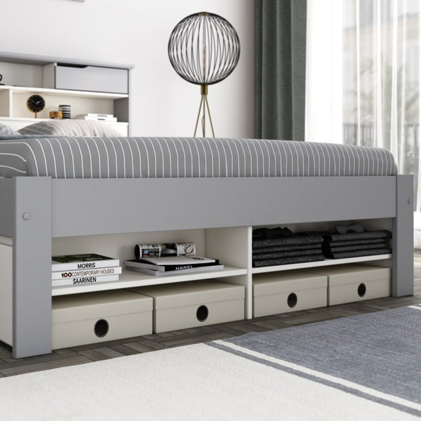 Grey bed with storage drawers in a modern bedroom setting