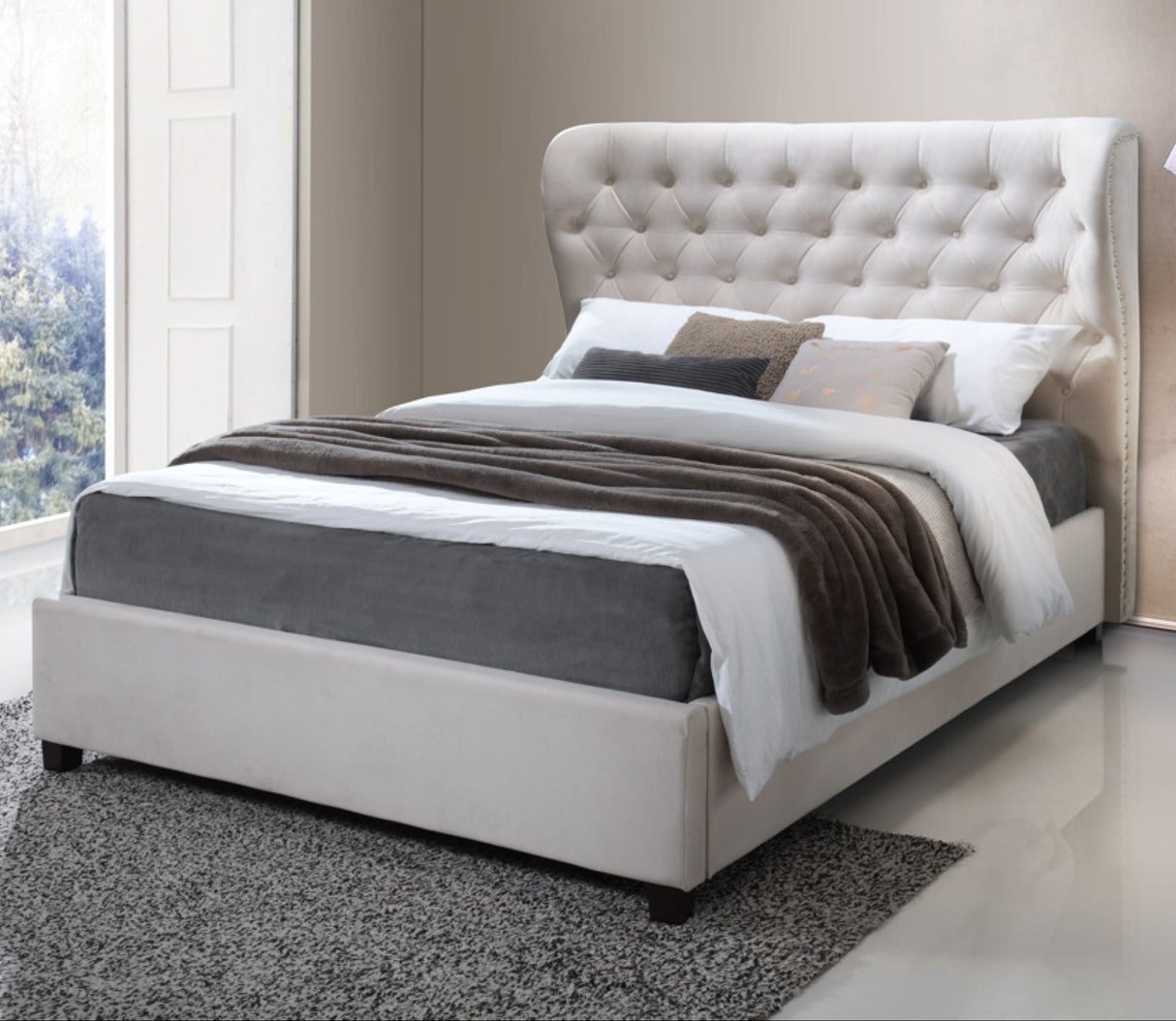 A cream upholstered bed frame with a padded headboard, displayed in a stylish bedroom setting.
