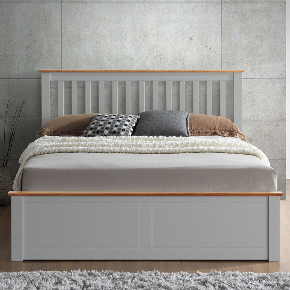Grey bed with wooden accents against a grey wall.