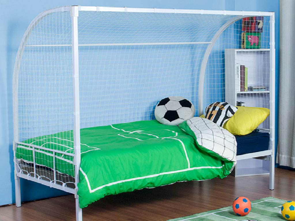 A white football goal bed frame designed for a single bed, placed in a child's bedroom with bedding and a soccer ball decoration.
