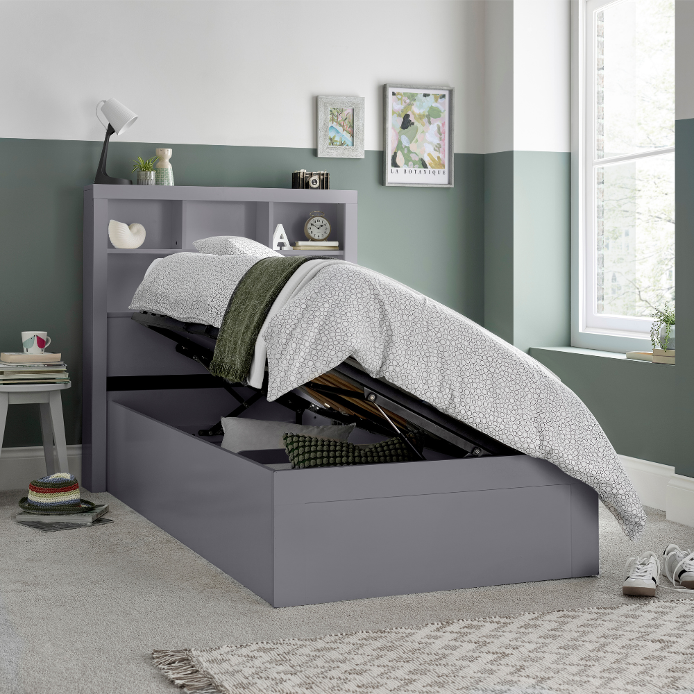 Grey bed with storage drawers in a bedroom setting