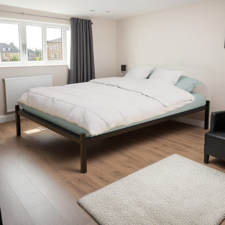 A Platform Metal Bed Frame in a room with a white mattress, black chair, and a wall-mounted TV.