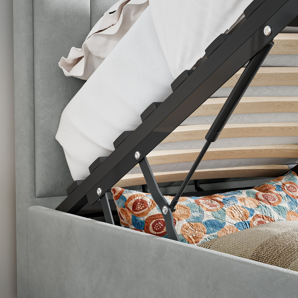 Grey bed with wooden slats and floral cushion.