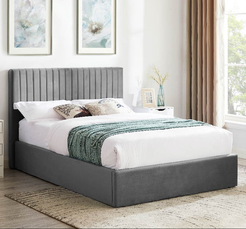 A smoked grey fabric ottoman bed frame with a hydraulic lift storage system, featured in a stylish bedroom setting.