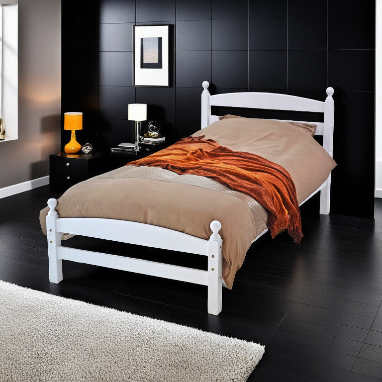 A single wooden bed frame with a beige headboard and footboard, placed on a bedroom setting with a mattress on top, a nightstand on each side, and a decorative rug on the floor.
