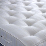 Close-up of a white mattress with quilted surface