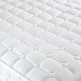 Close-up of a white mattress with hexagonal foam cells