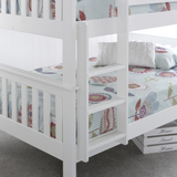 White bunk bed with floral bedding on a grey floor