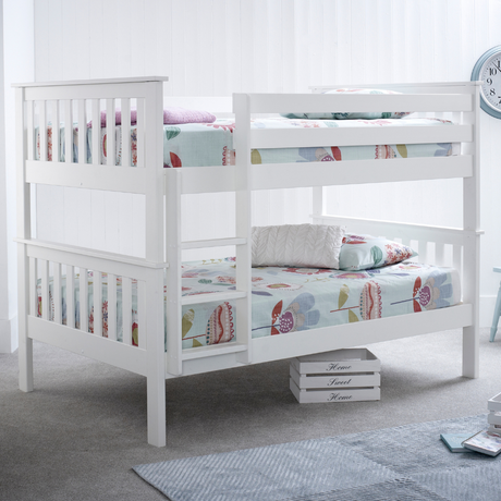 White bunk bed with floral bedding in a room setting